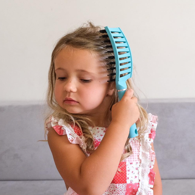little girl using practigal tangle tamer hairbrush nz
