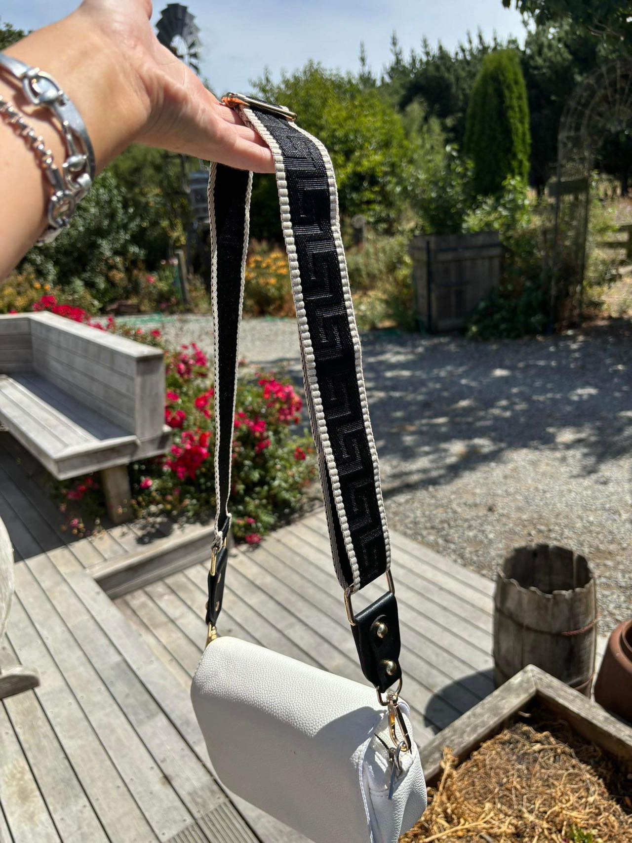 practigal black bag strap and white leather bag